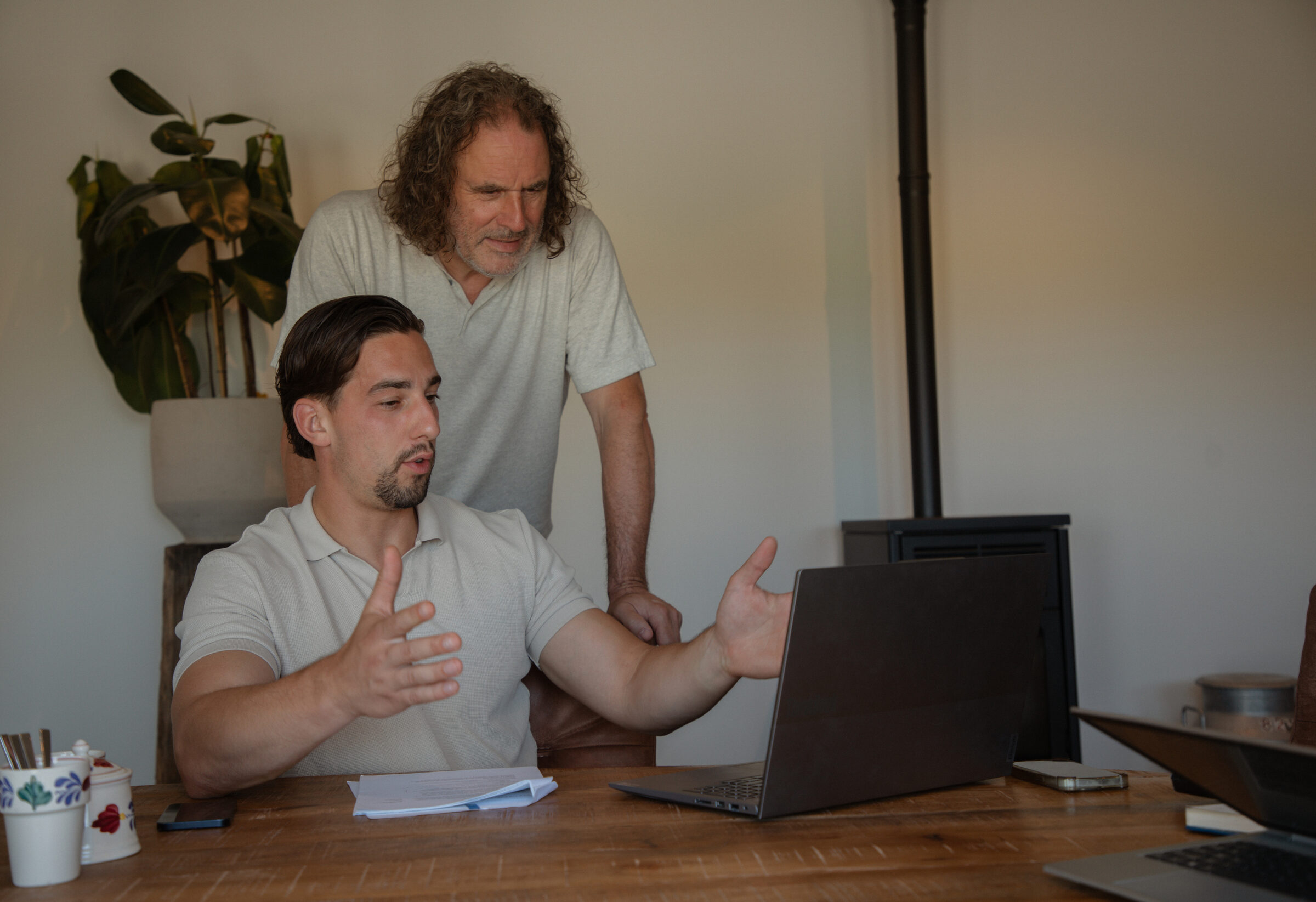 Twee collega's van GreenDee in overleg achter een laptop